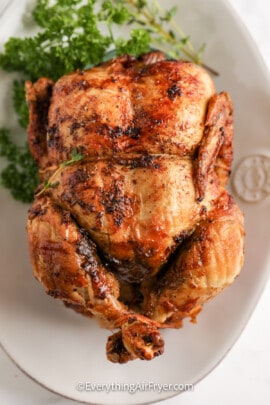 whole rotisserie chicken on a plate