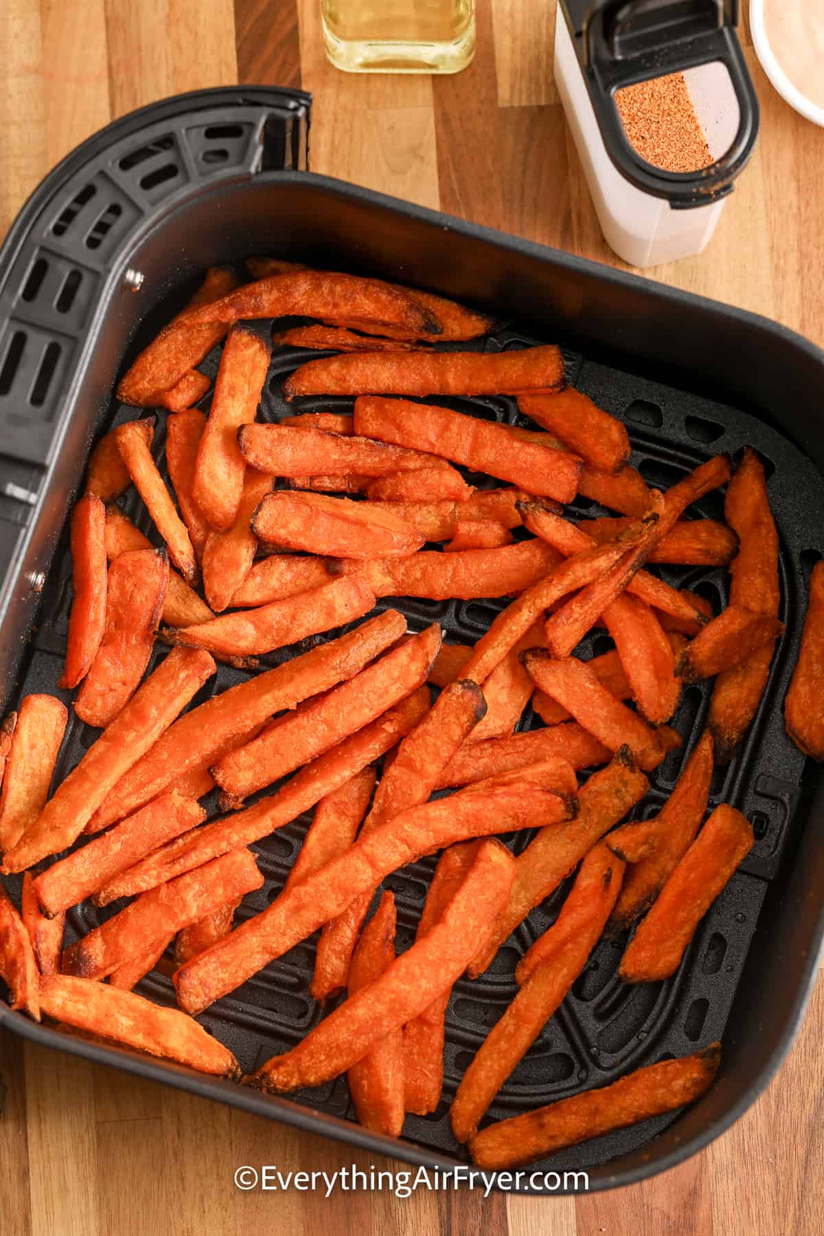 cooked sweet potato fries in an air fryer tray