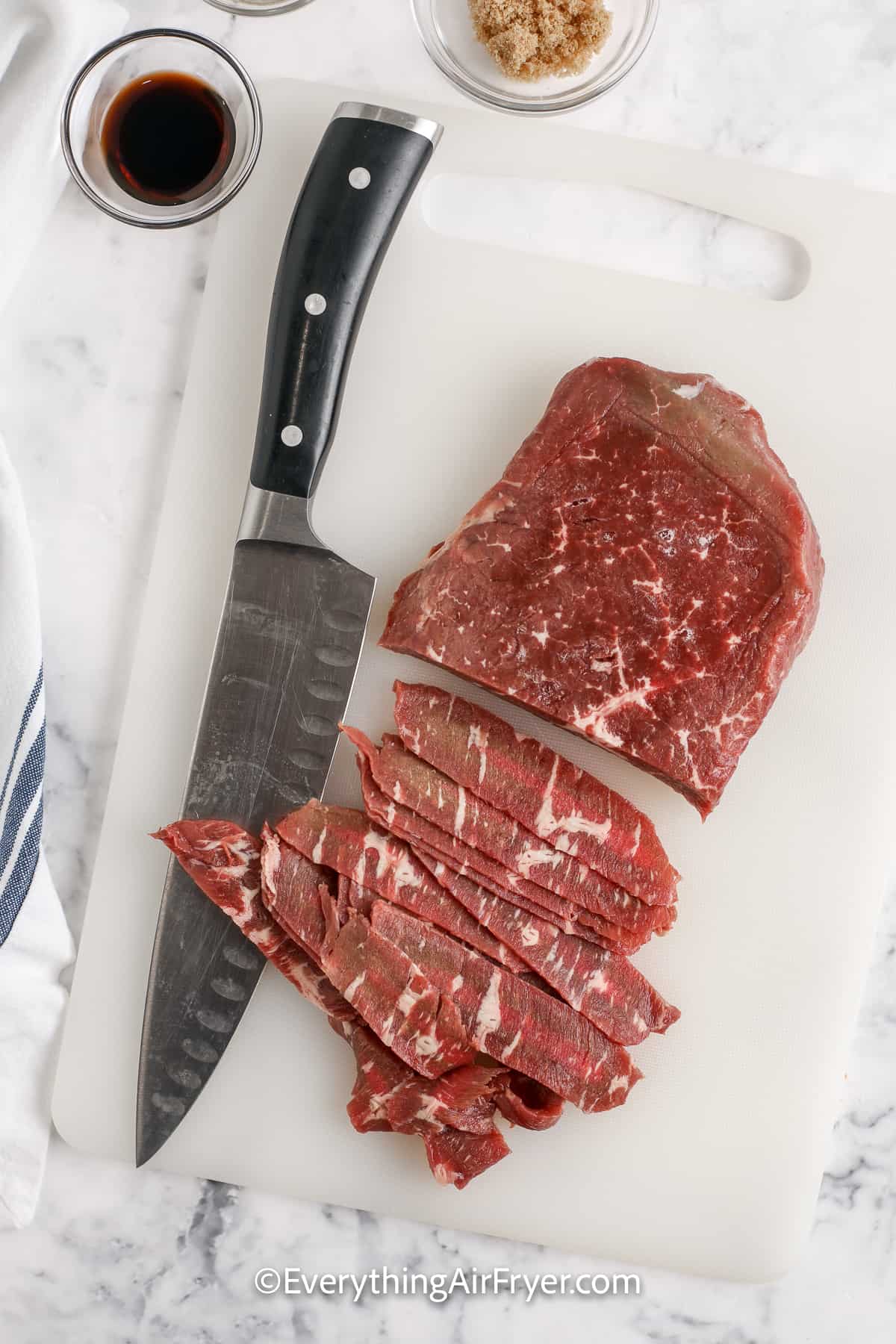 steak being sliced on a cutting board