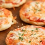 air fryer three cheese mini pizzas on a cutting board with text