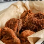 fried chicken in a dish with text