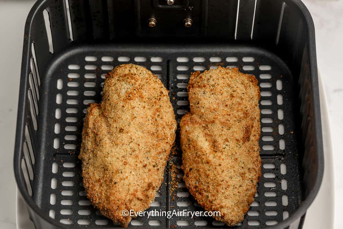 cooked breaded chicken in an air fryer tray
