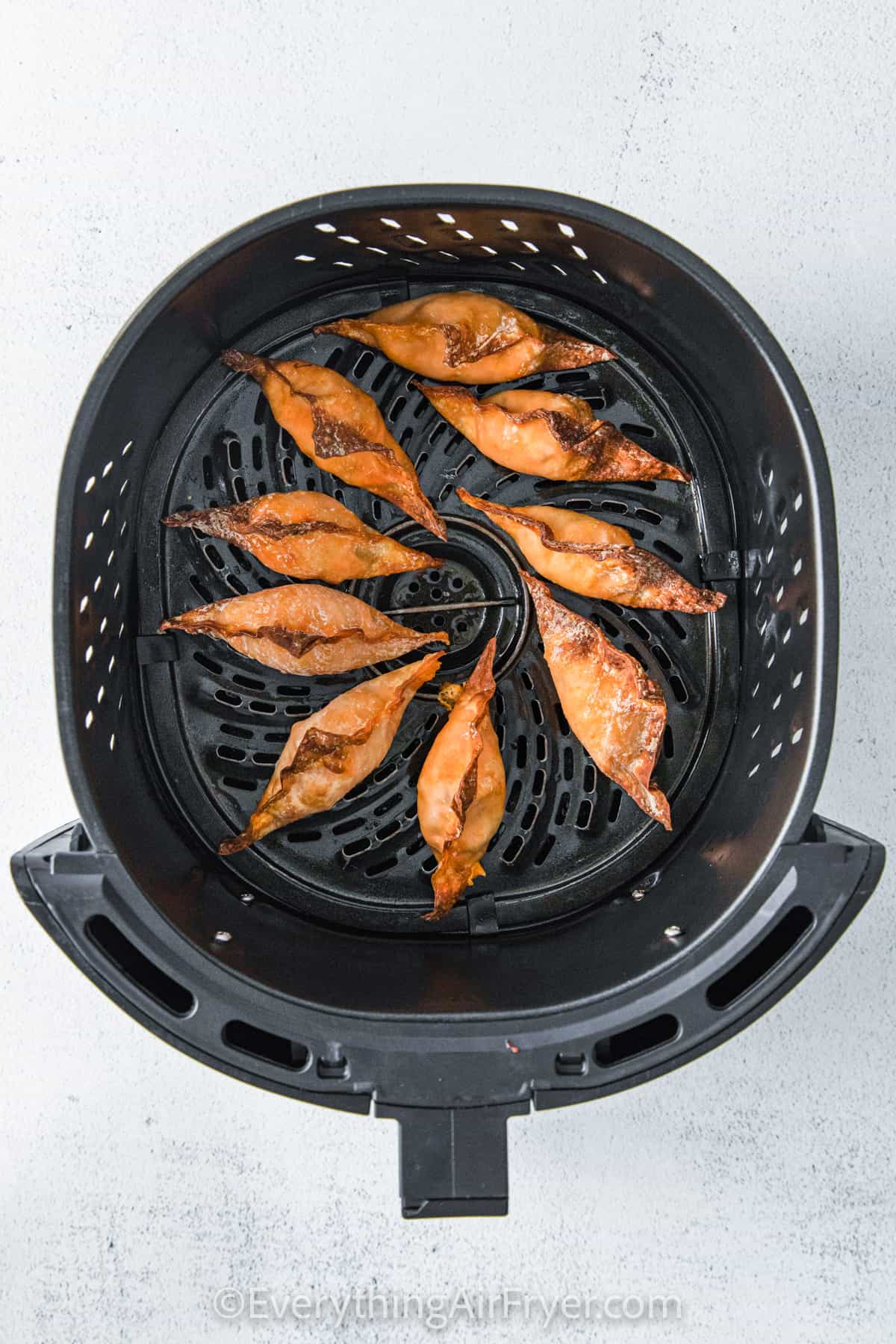 cooked Air Fryer Buffalo Chicken Wontons in the fryer