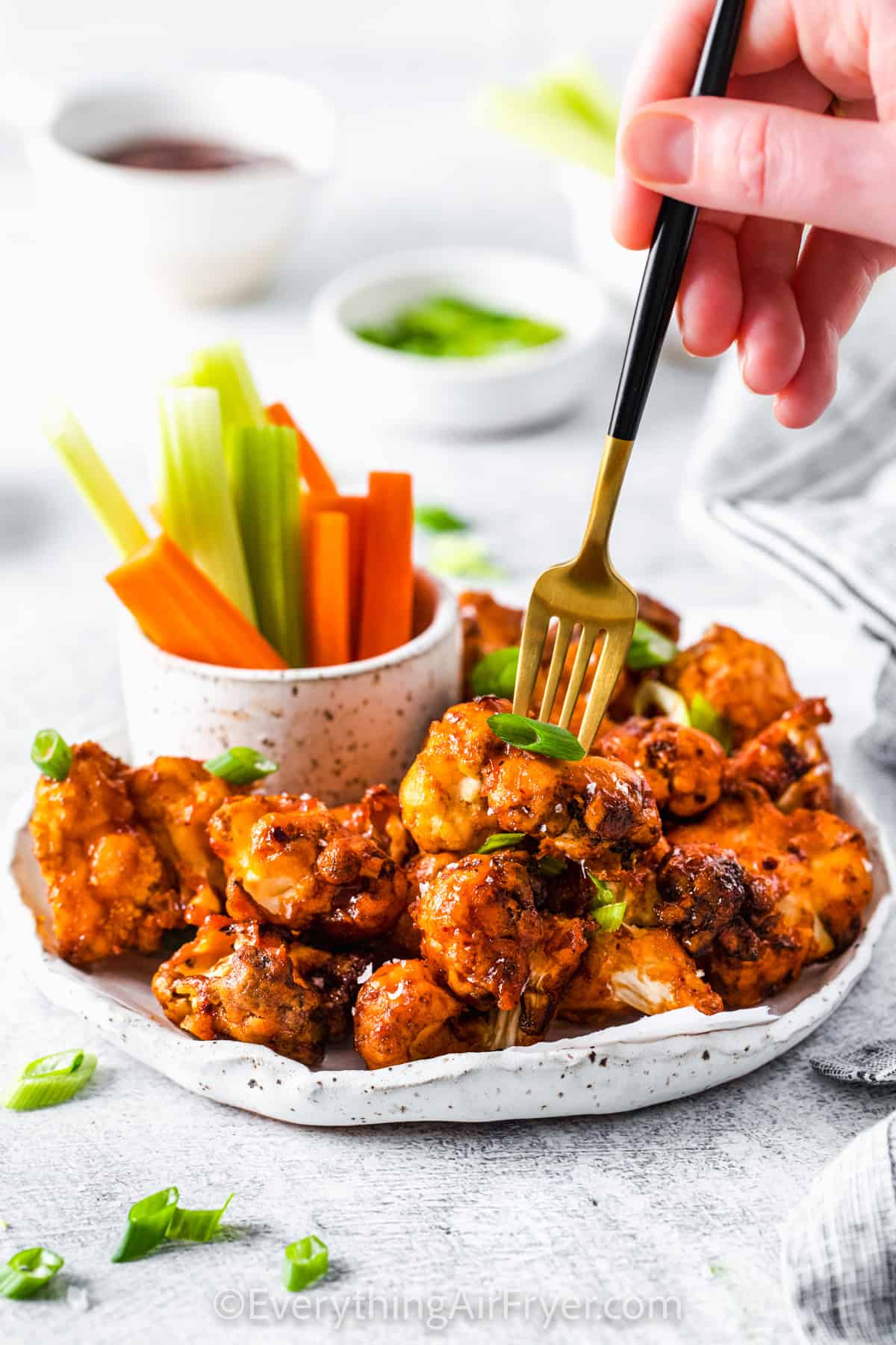 plated Air Fryer Cauliflower Wings with a fork