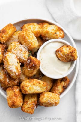 dipping Homemade Air Fryer Tater Tots in sauce