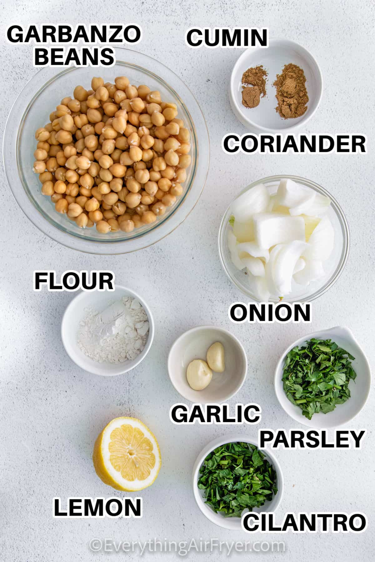 garbanzo beans , cumin , coriander , onion , flour , garlic , parsley , cilantro , and lemon in bowls to make Air Fryer Falafel with labels