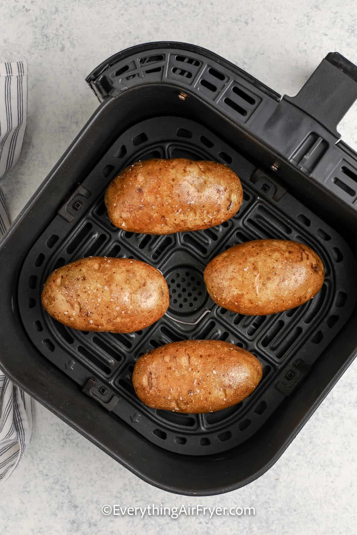 air fryer baked potato in an air fryer tray