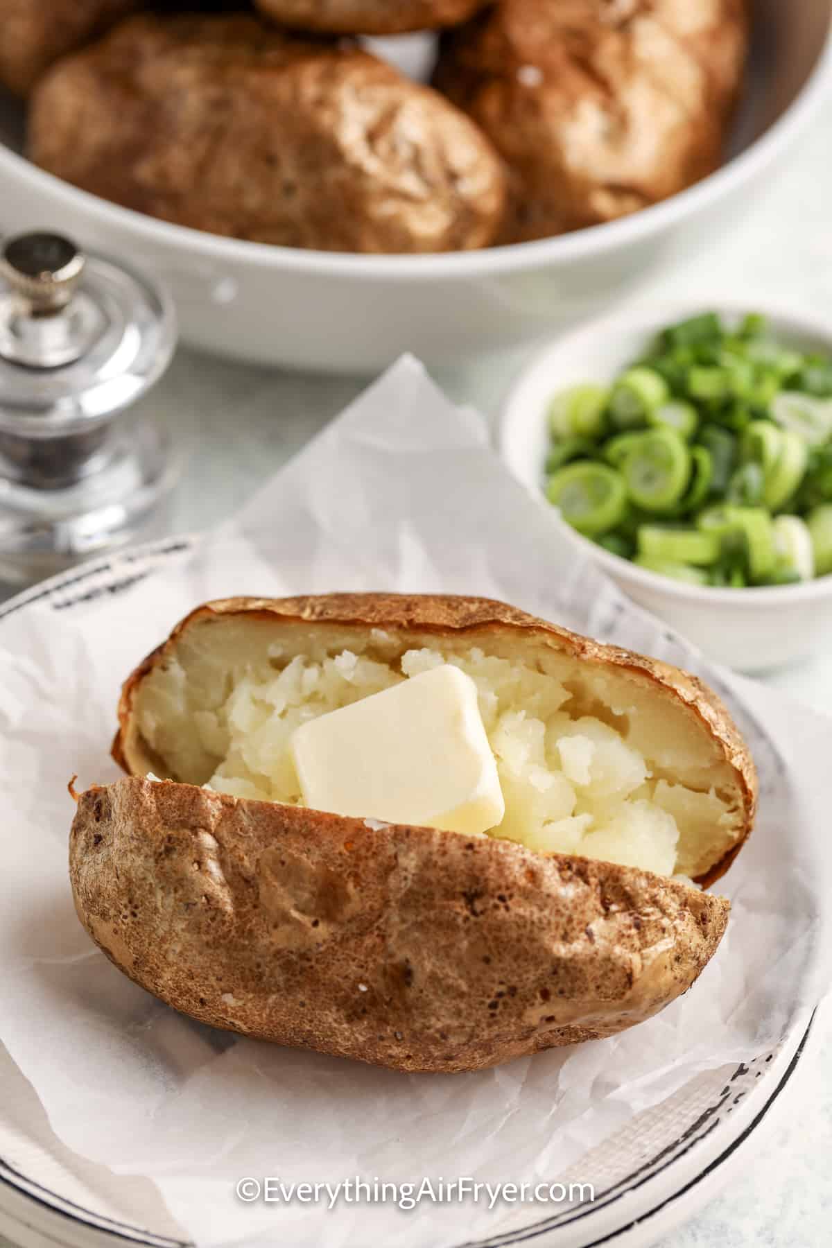 air fryer baked potato topped with butter