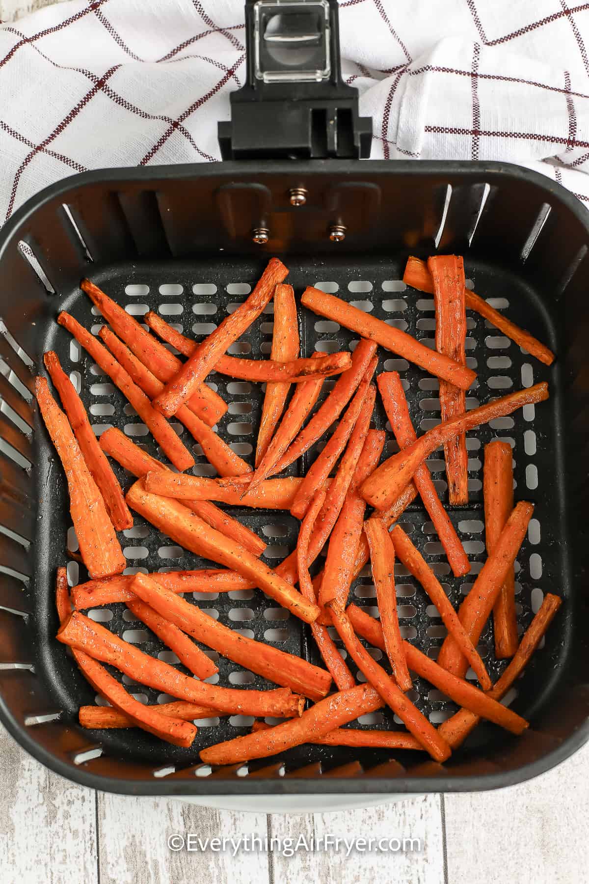 cooked carrots in an air fryer tray