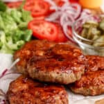 air fryer turkey burgers on a cutting board with other burger toppings