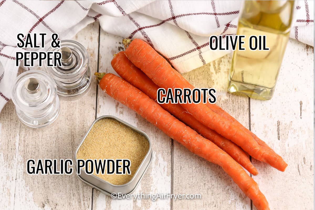 ingredients assembled to make air fryer carrot fries, including carrots, salt and pepper, olive oil, and garlic powder