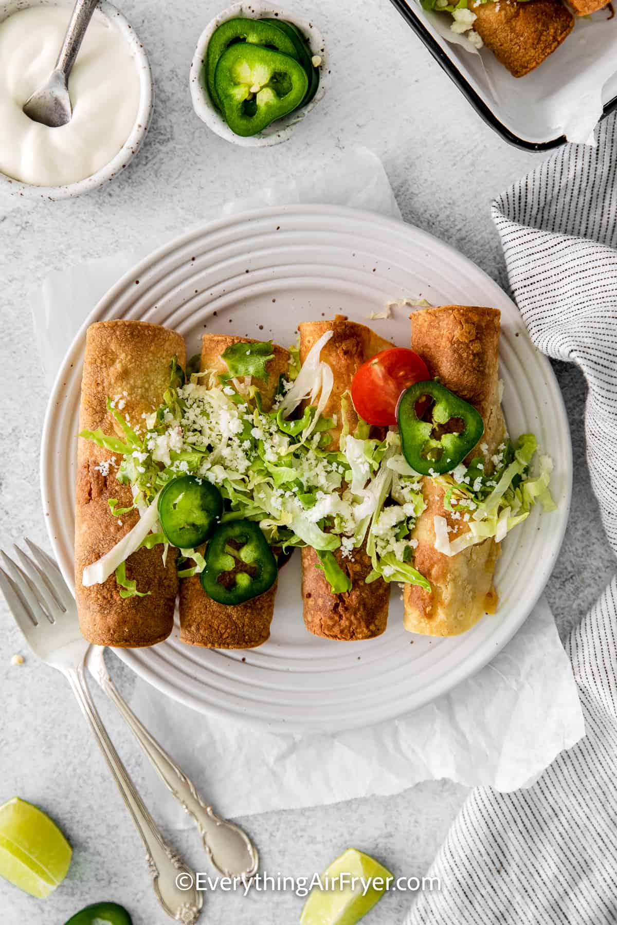 air fryer chicken taquitos on a plate with toppings
