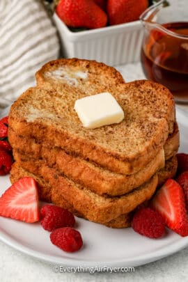 stack of air fryer french toast on a plate with strawberries