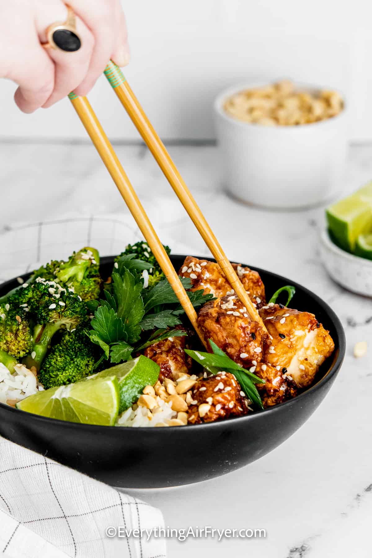 air fryer sesame chicken in a bowl with rice and broccoli