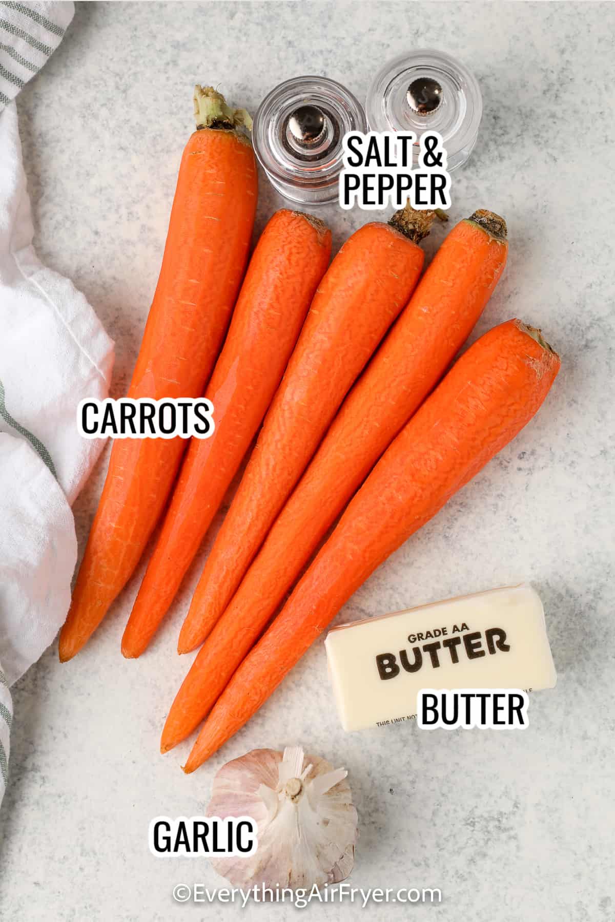 ingredients assembled to make air fryer carrots including carrots, butter, garlic, and salt and pepper