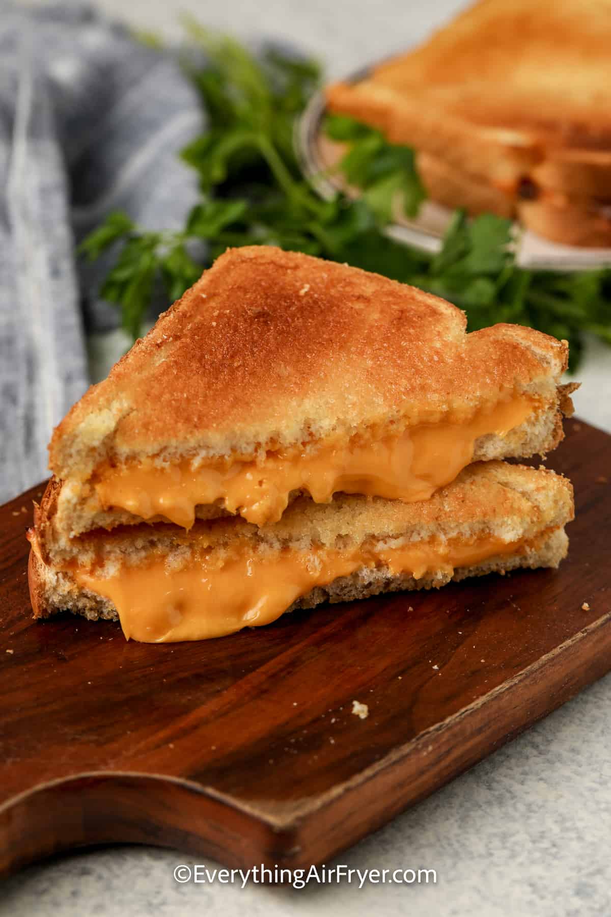 sliced air fryer grilled cheese sandwich on a cutting board