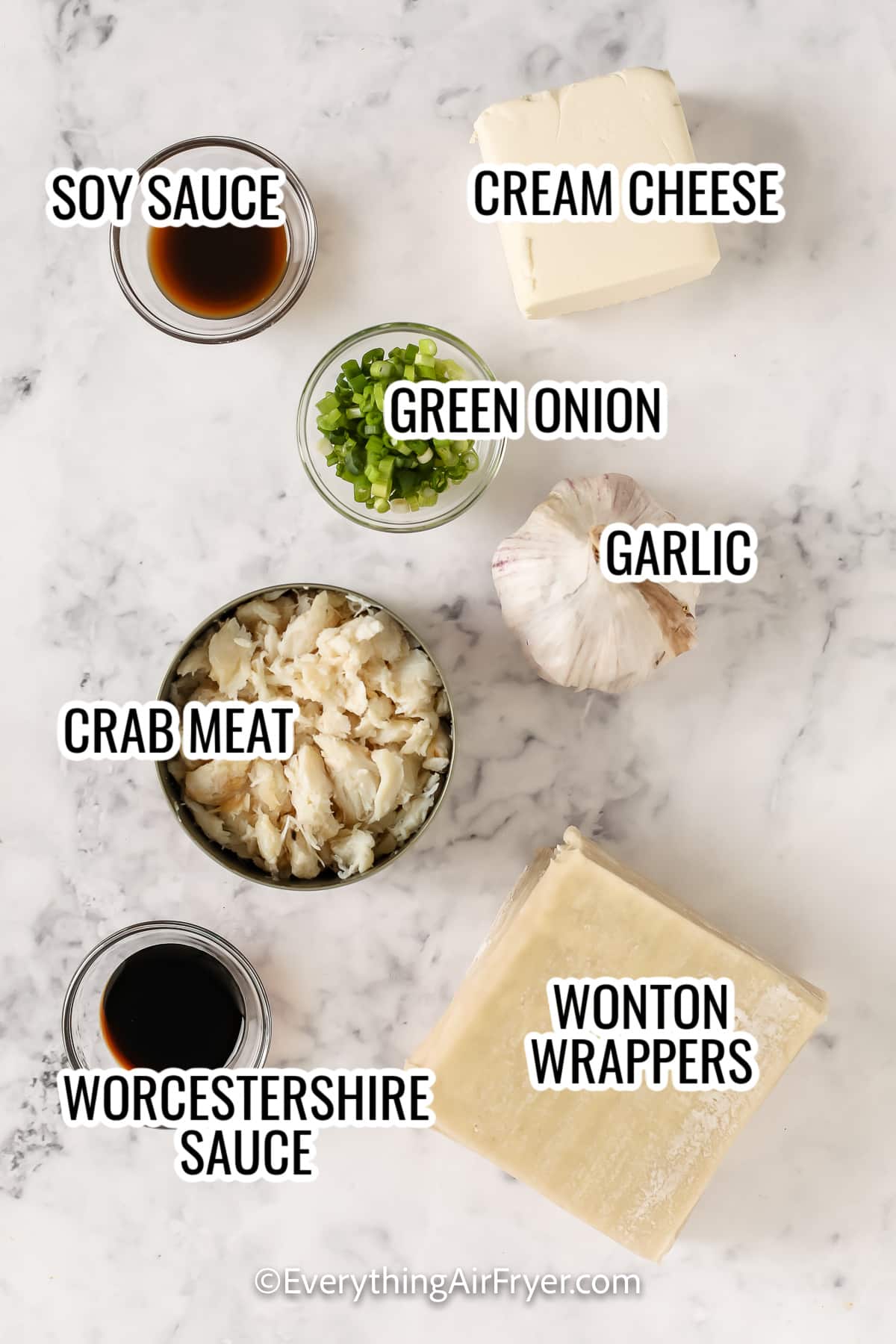 ingredients assembled to make air fryer crab rangoon, including sot sauce, crab meat, wonton wrappers, garlic, cream cheese, green onion, and worcestershire sauce
