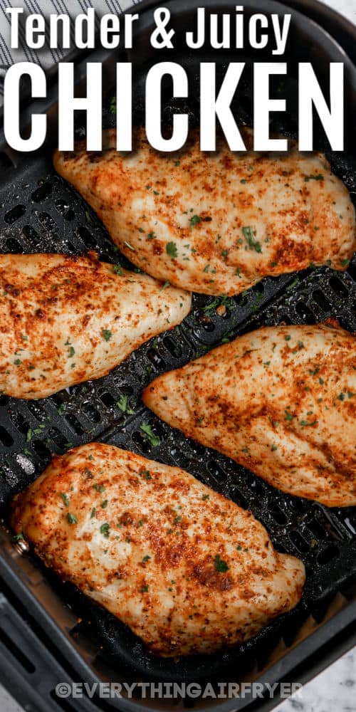 cooked Air Fryer Chicken Breasts in the fryer with writing
