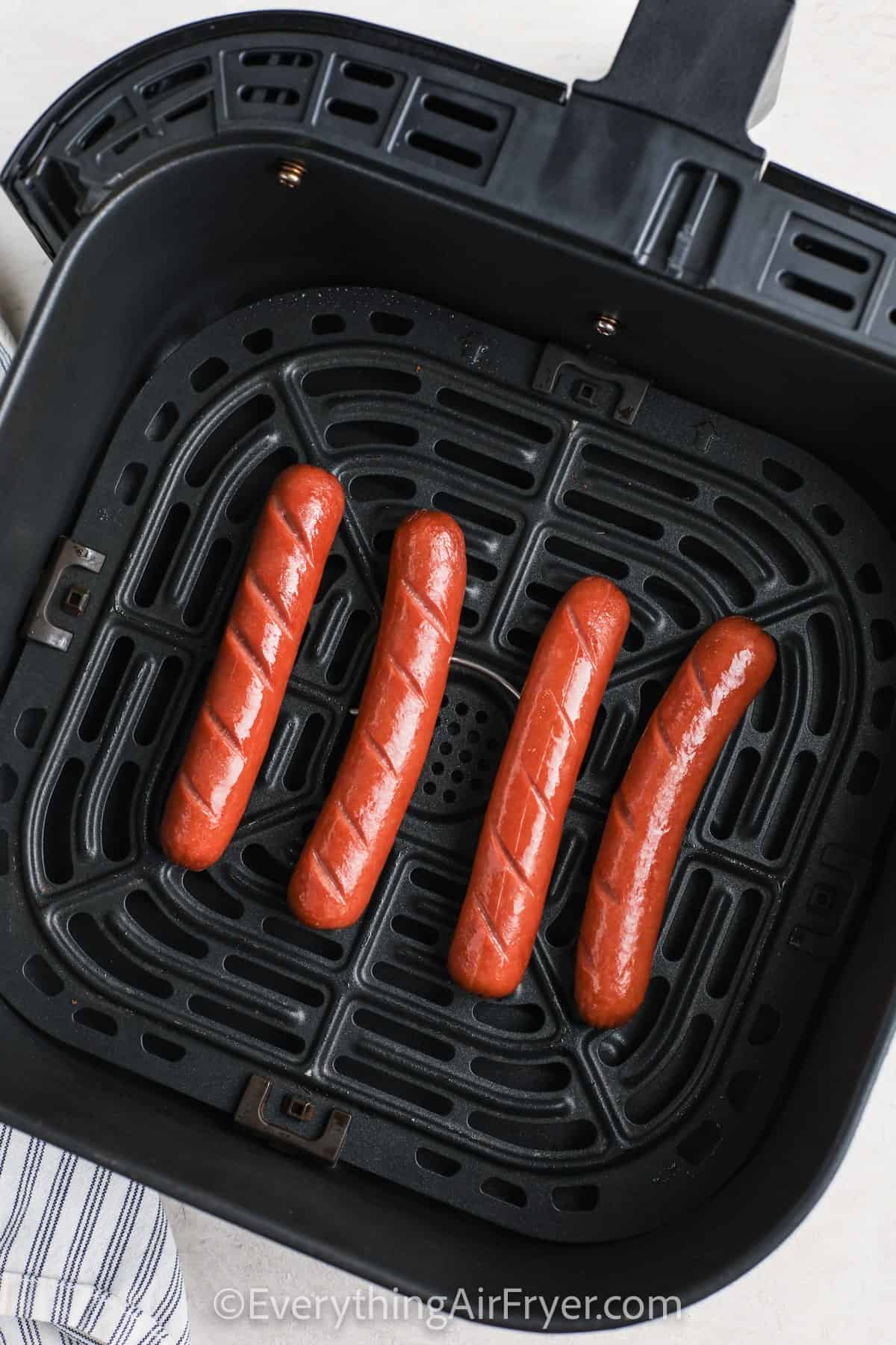 cooking hot dogs to make Air Fryer Hot Dogs