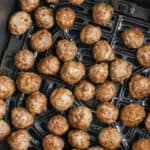 cooked Air Fryer Frozen Meatballs in the fryer with a title