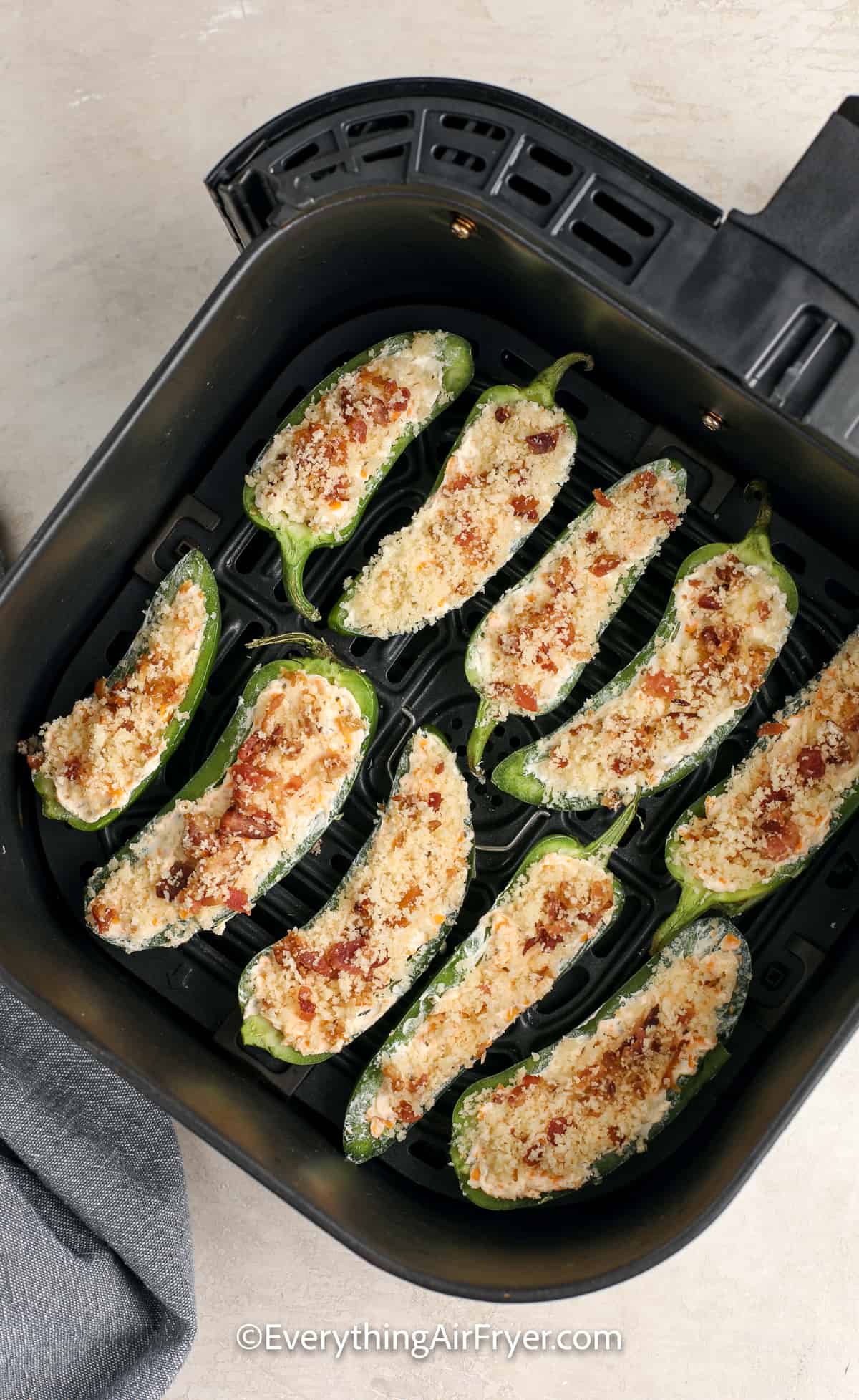 uncooked air fryer jalapeno poppers in an air fryer tray