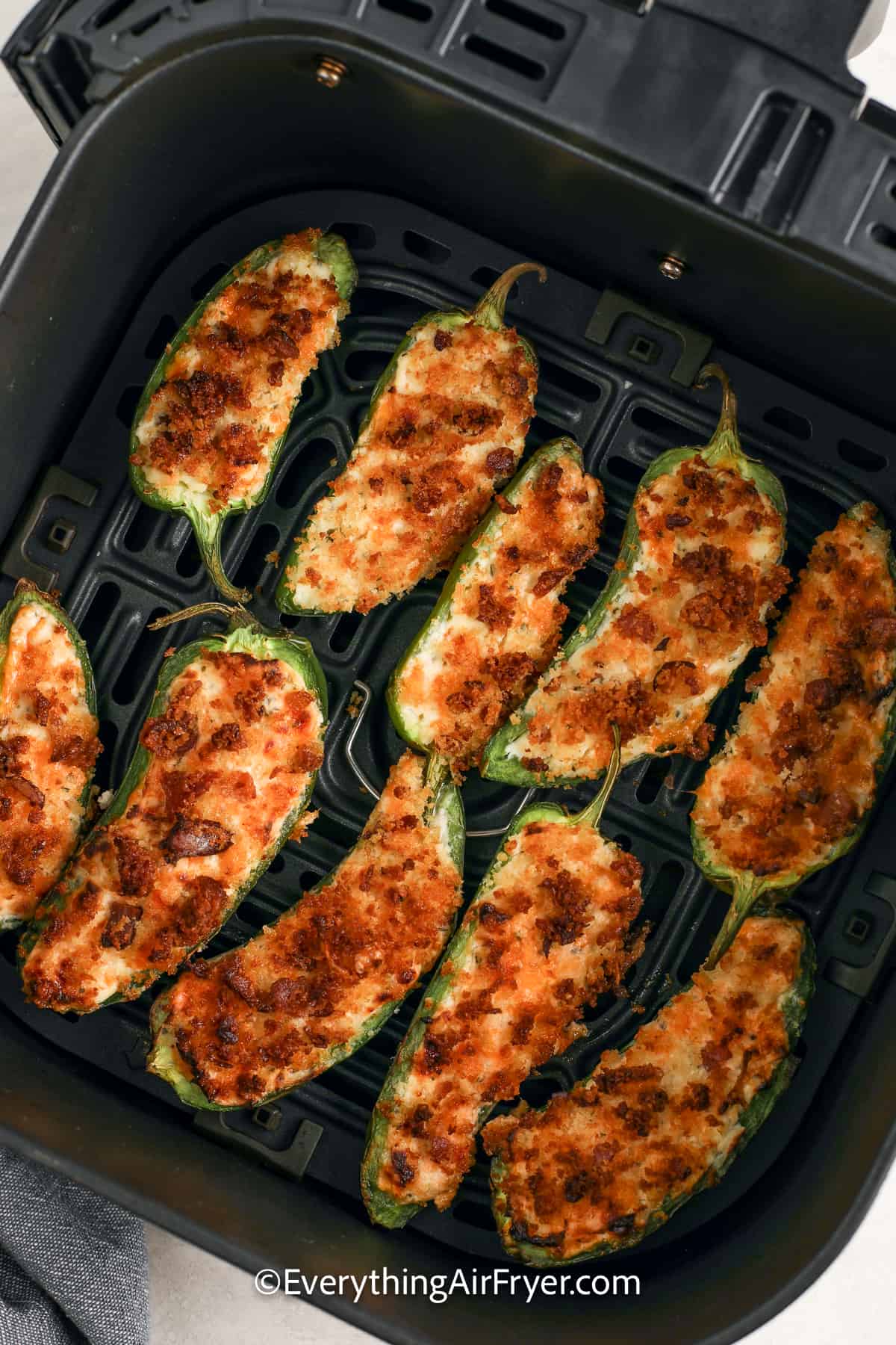 cooked air fryer jalapeno poppers in an air fryer tray