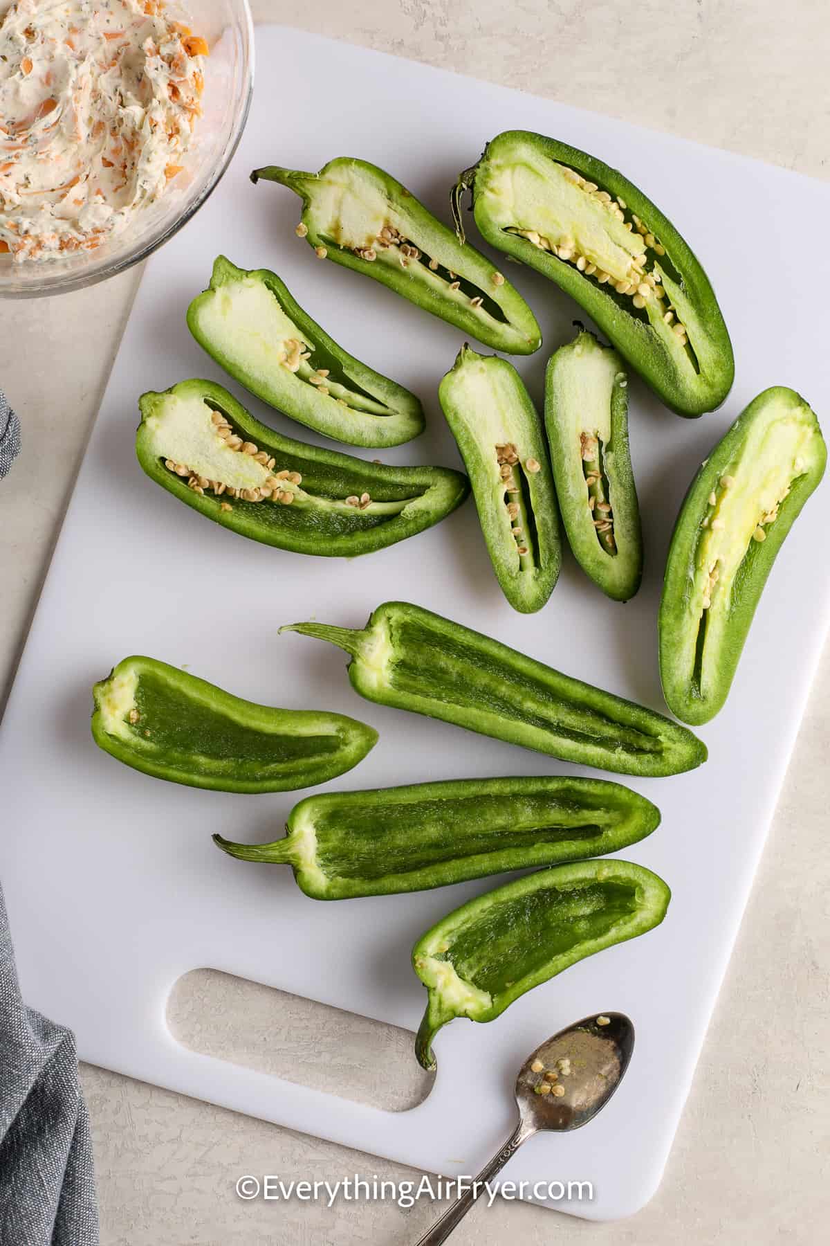 sliced jalapenos on a cutting board
