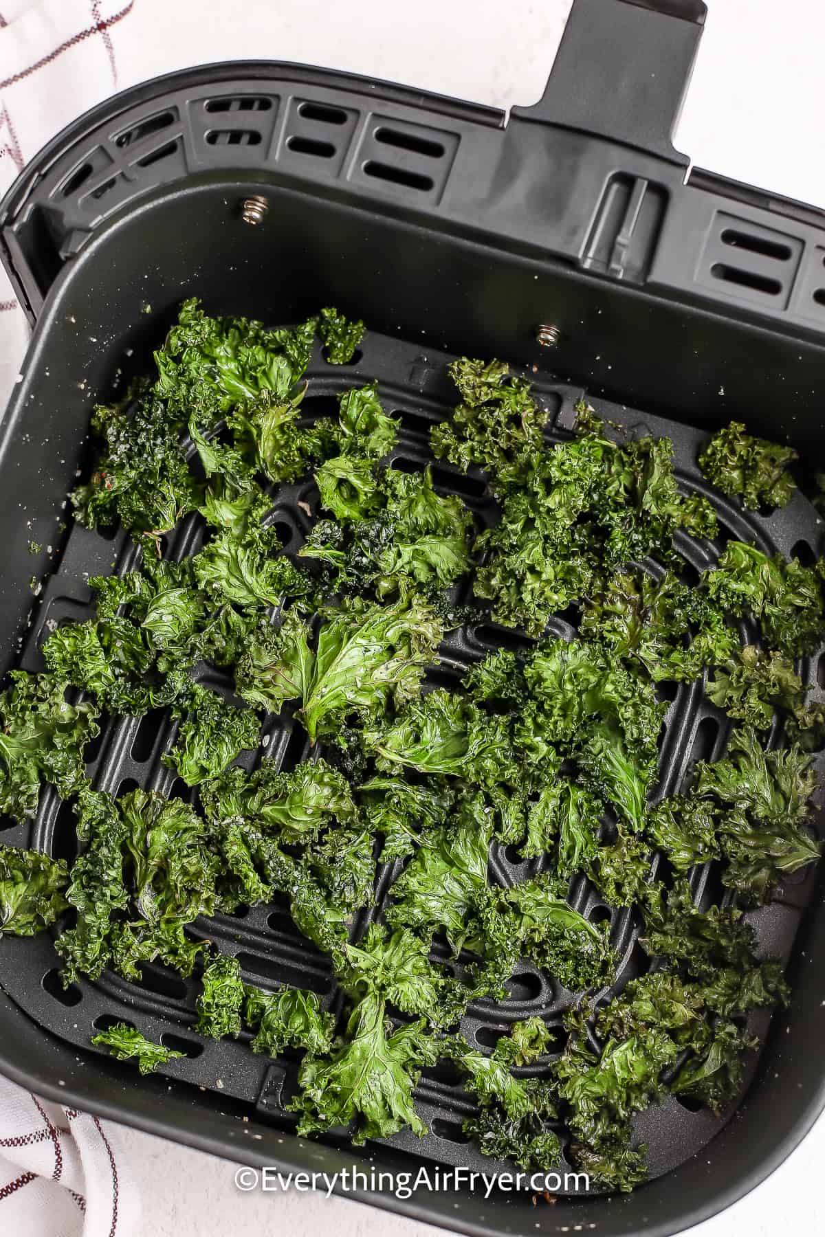 cooked kale chips in an air fryer tray