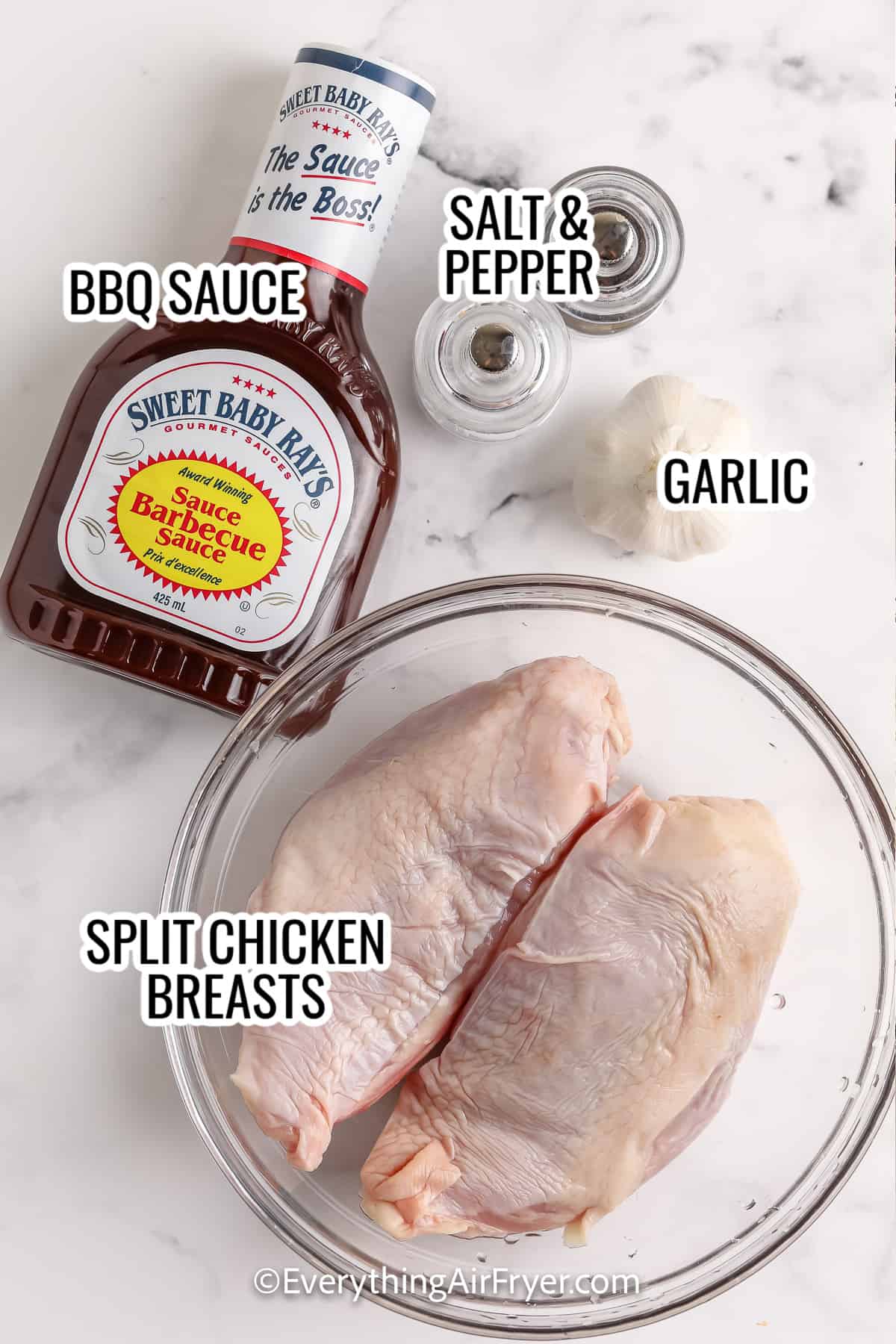 ingredients assembled to make air fryer bbq chicken breasts including bbq sauce, chicken breast, salt and pepper, and garlic