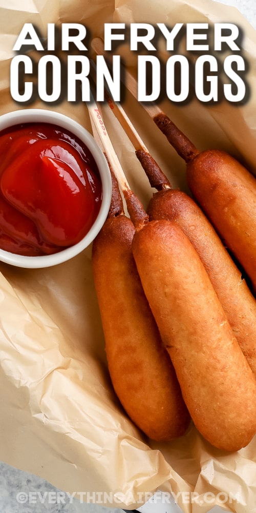 air fryer corn dogs in a basket with text