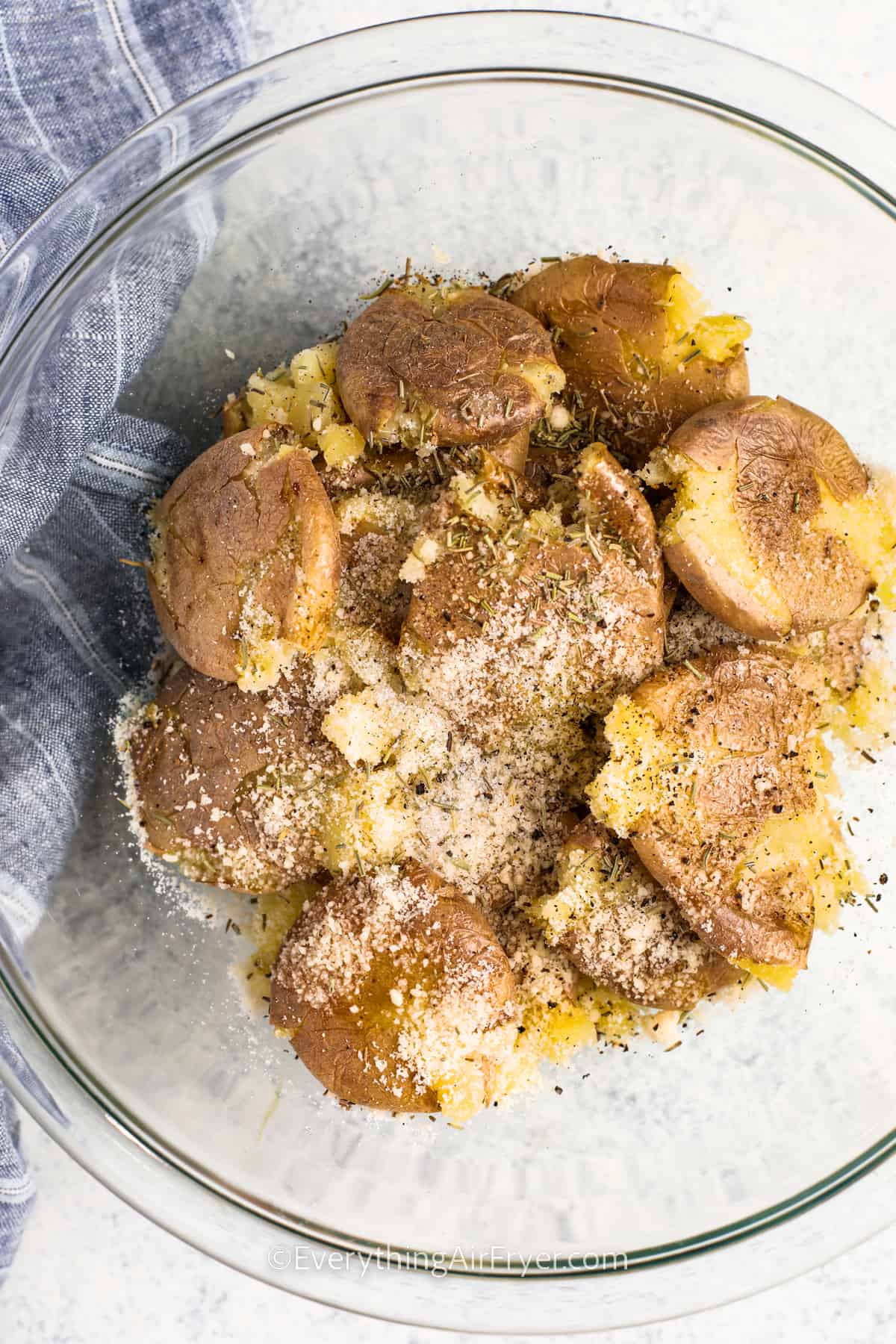 adding seasonings to Air Fryer Smashed Potatoes