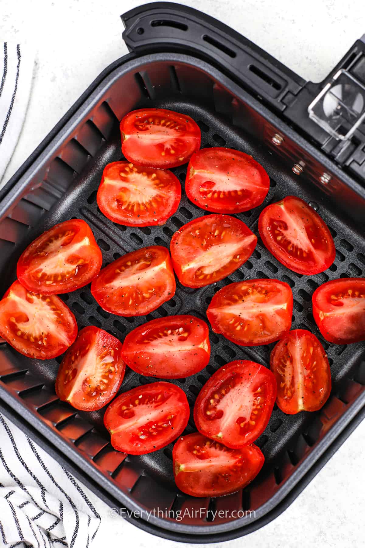 Air Fryer Tomatoes in the fryer before cooking
