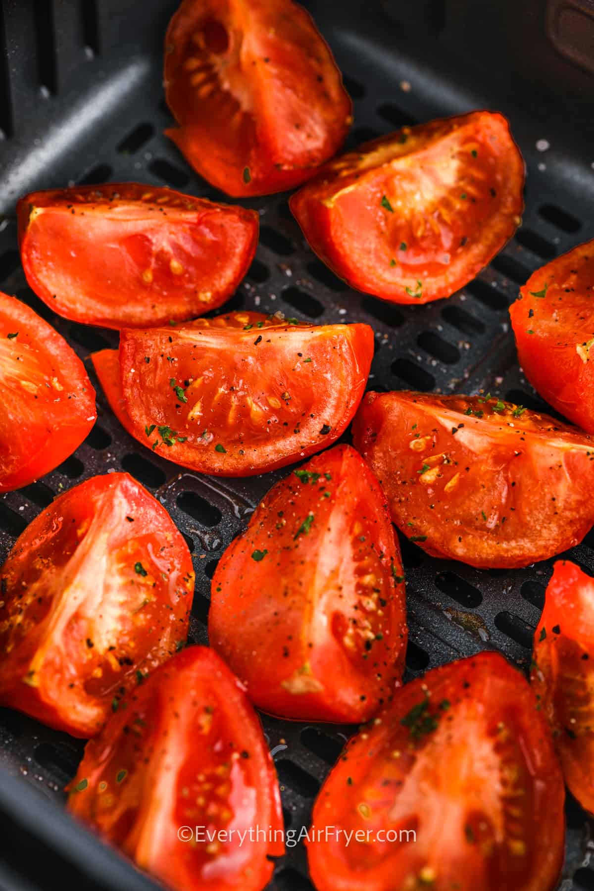 close up of Air Fryer Tomatoes in the fryer