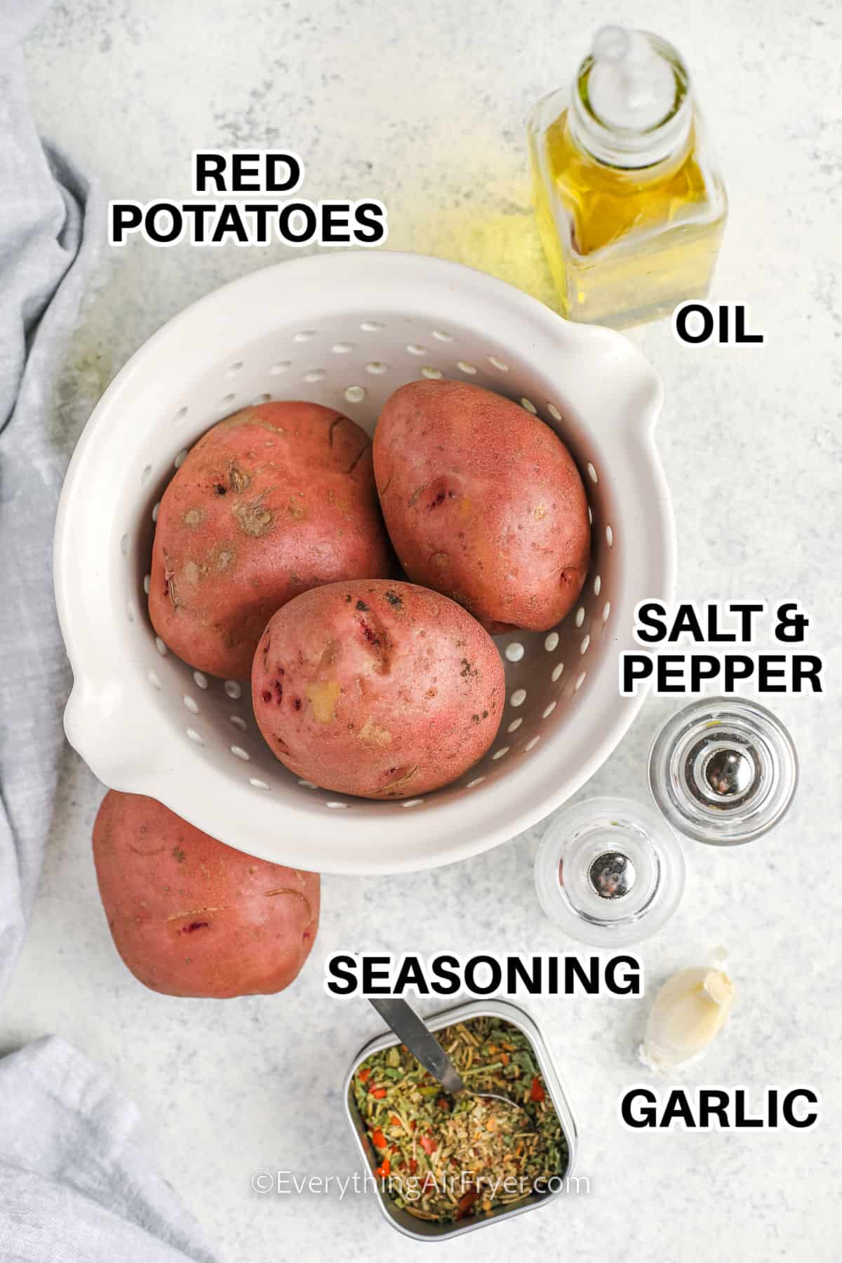 red potatoes , oil , salt and pepper , seasoning, and garlic with labels to make Air Fryer Red Potatoes