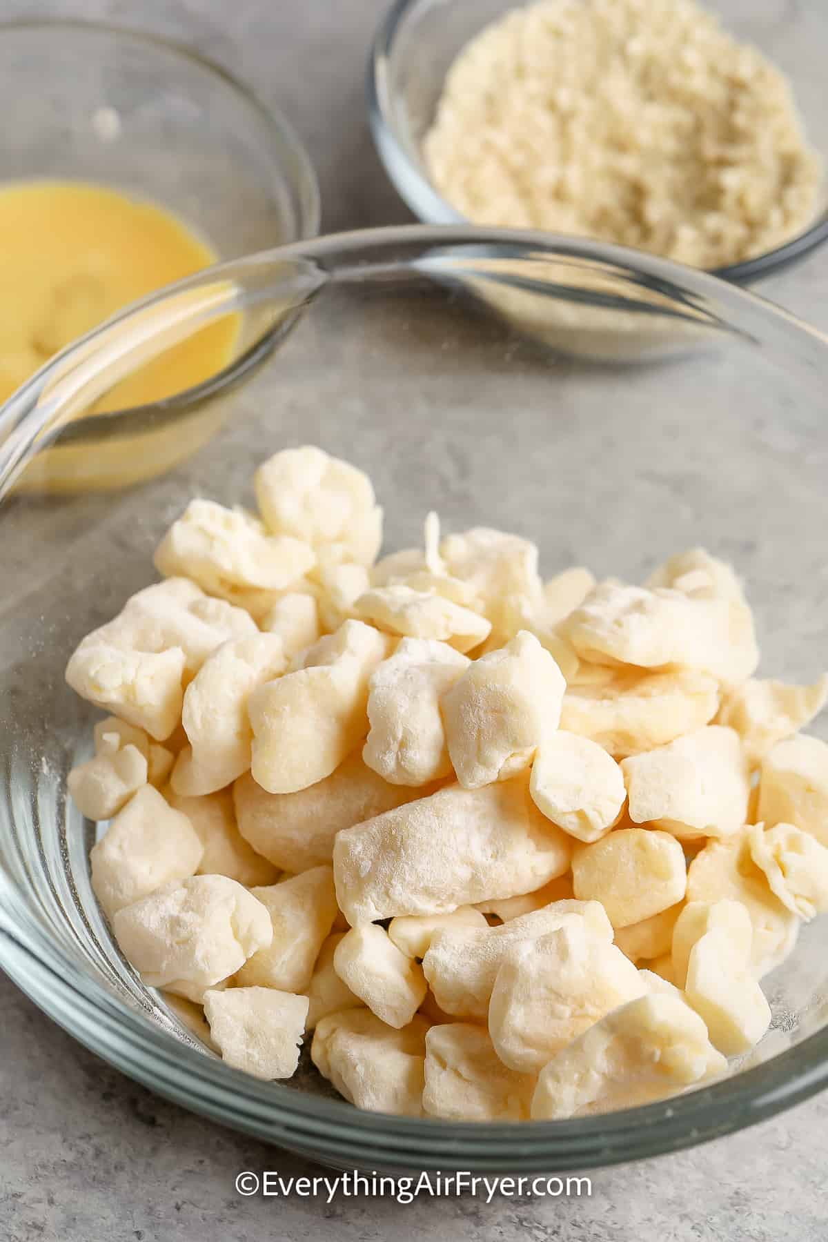 cheese curds in a bowl coated with flour