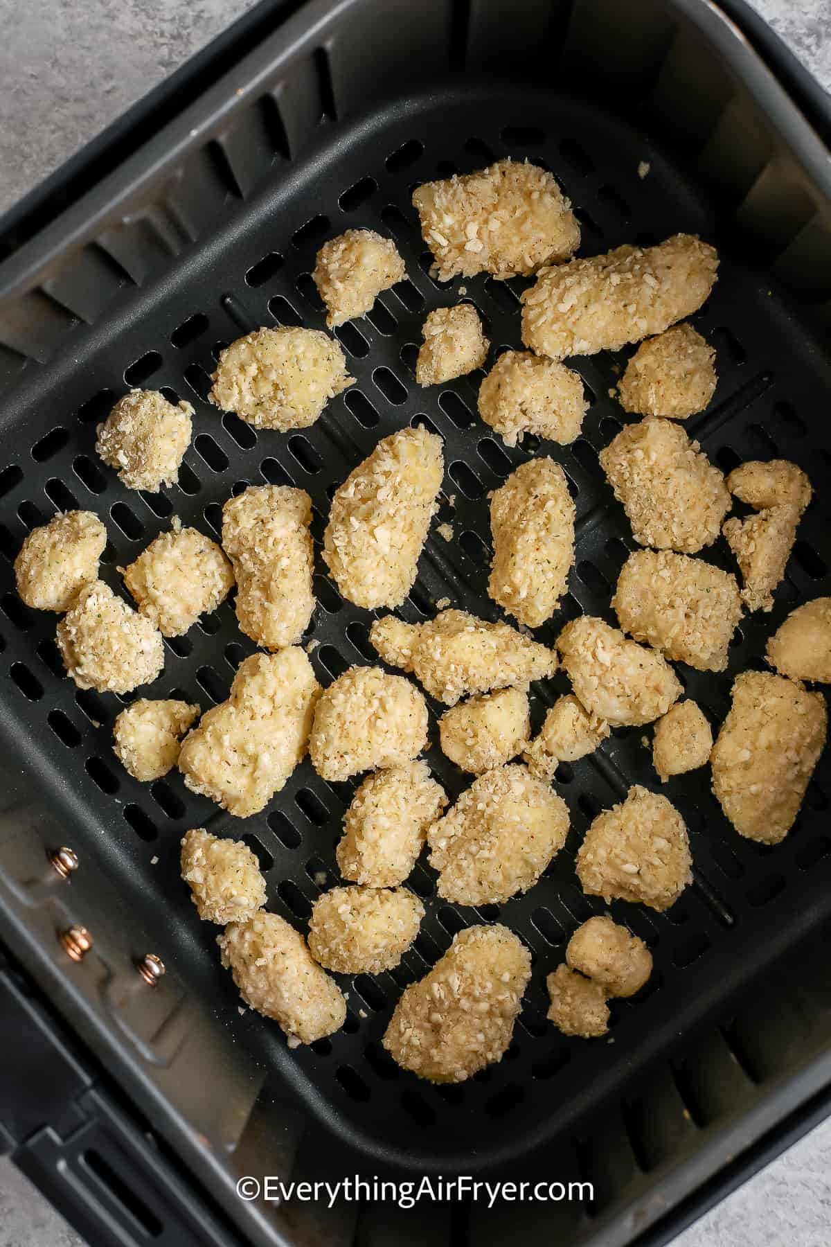 breaded cheese curds in an air fryer tray
