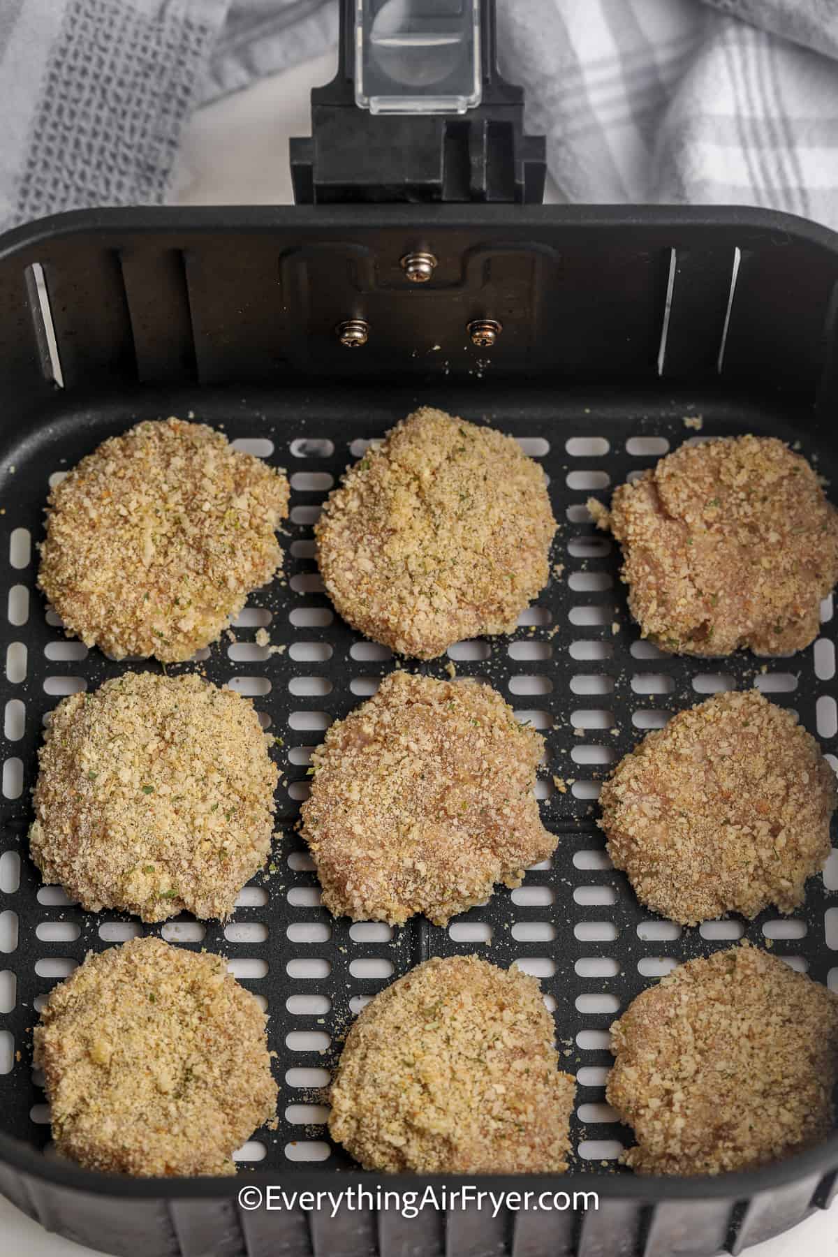 uncooked homemade chicken nuggets in an air fryer tray