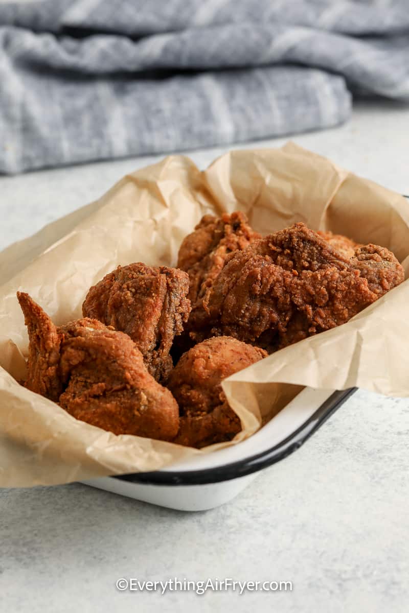 fried chicken in a dish lined with parchment paper