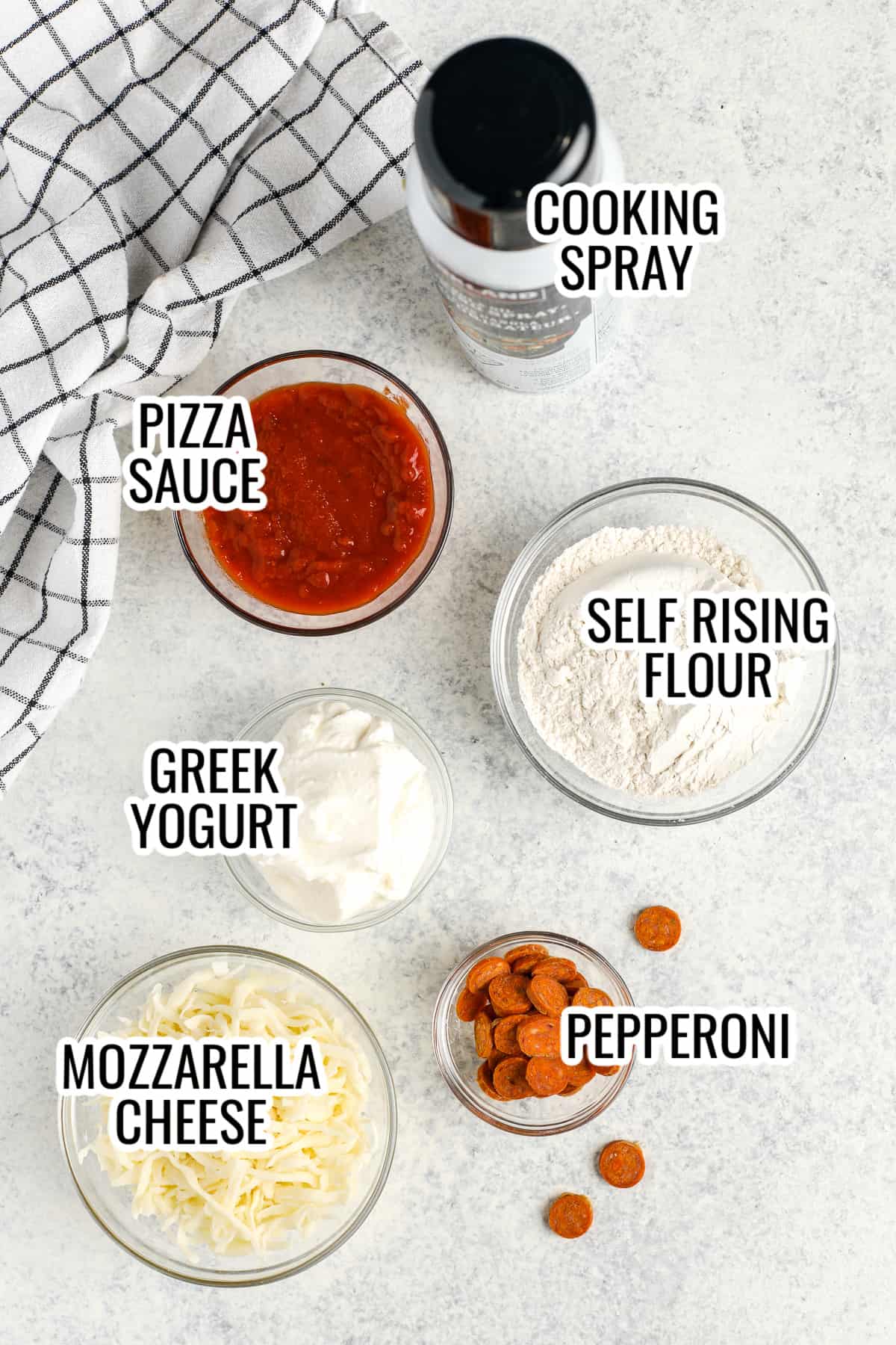 ingredients assembled to make air fryer pizza, including pizza sauce, four, greek yogurt, pepperoni, and mozzarella cheese