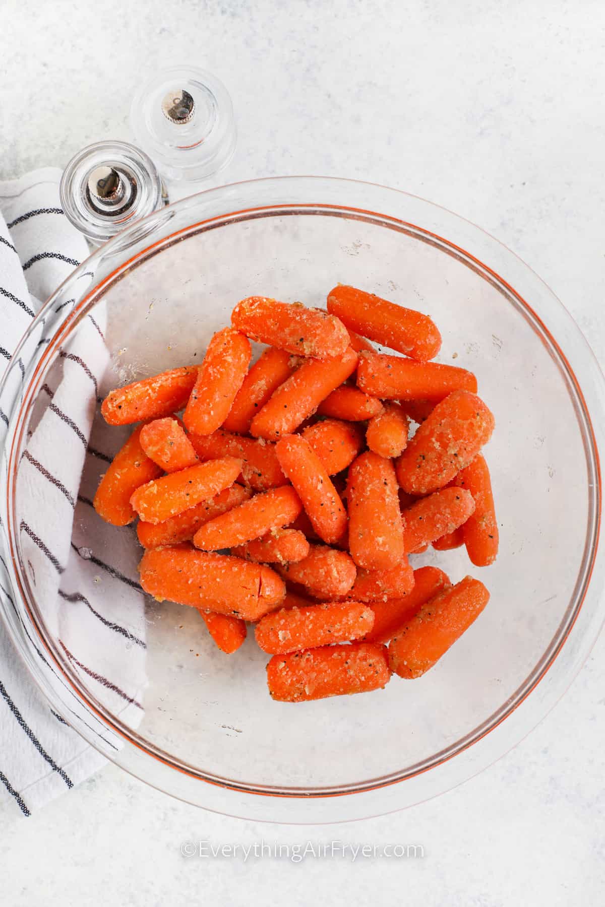 Air Fryer Baby Carrots seasoned in a bowl