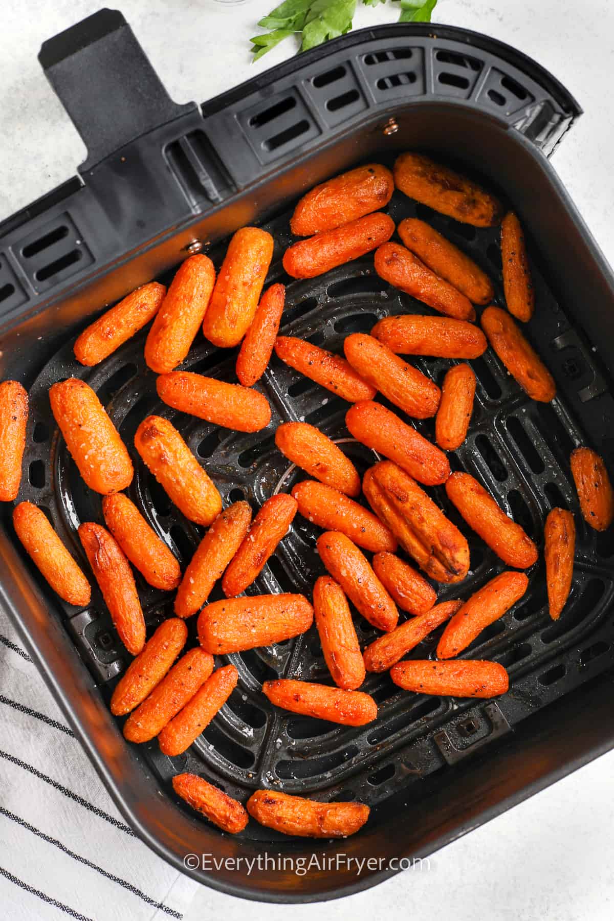 Baby carrots cooked in an air fryer basket