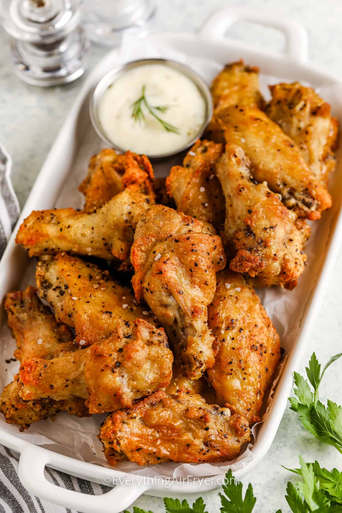a serving platter of air fryer chicken wings with dip
