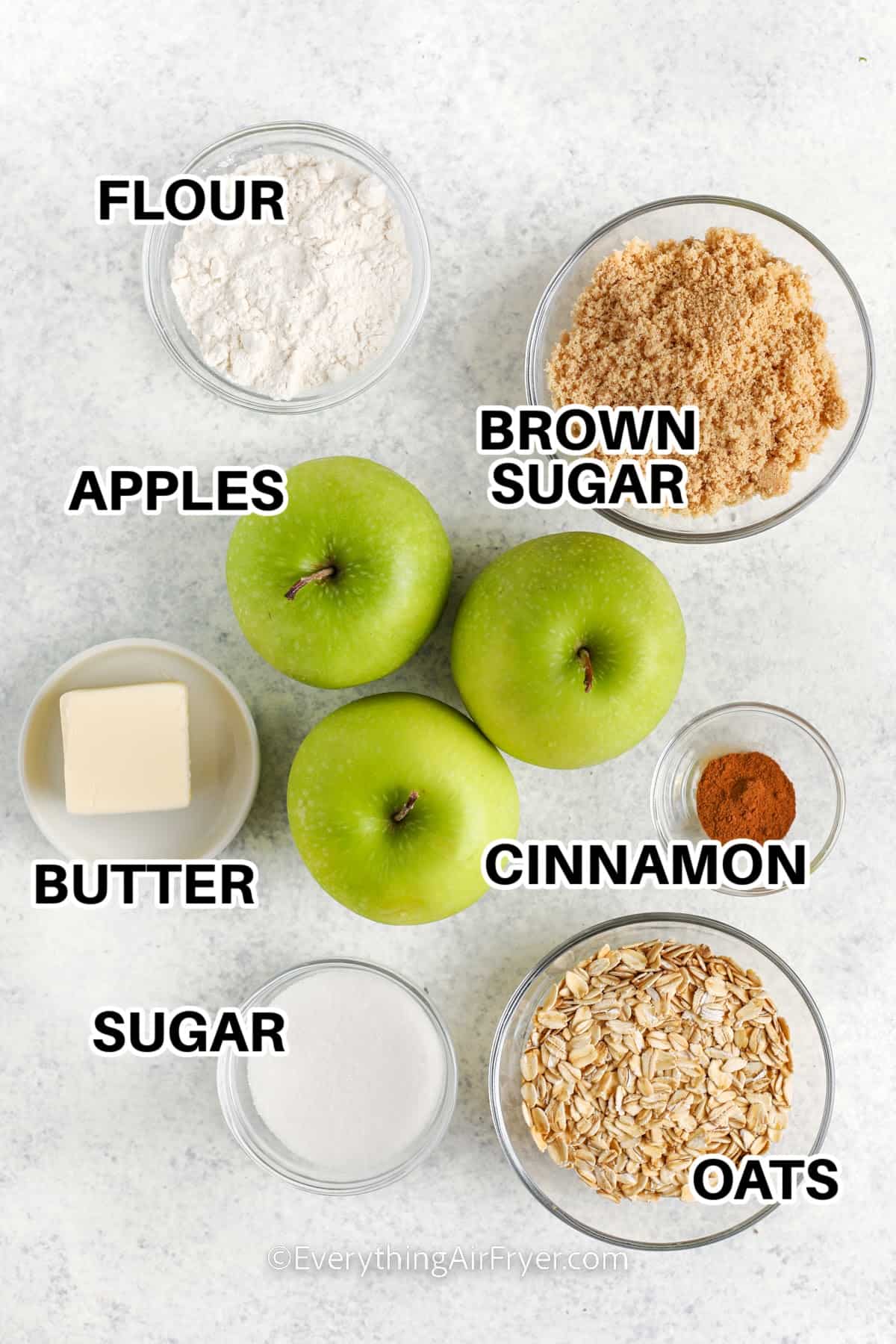 Air Fryer Apple Crisp ingredients labeled: flour, apples. brown sugar, butter, cinnamon, sugar, and oats