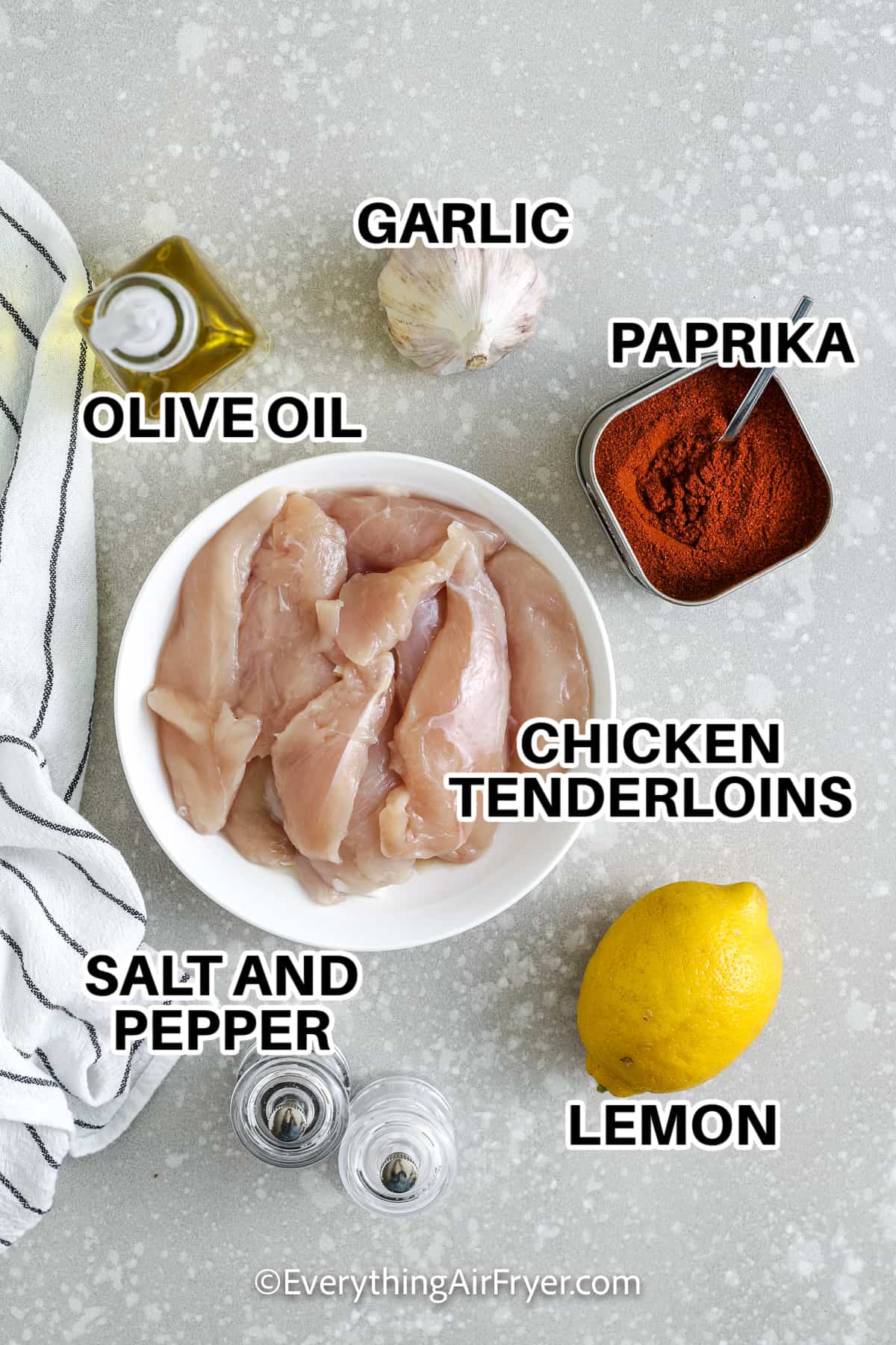 ingredients for air fryer chicken tenderloins including chicken tenderloins, olive oil, garlic, paprika, lemon, salt, and pepper