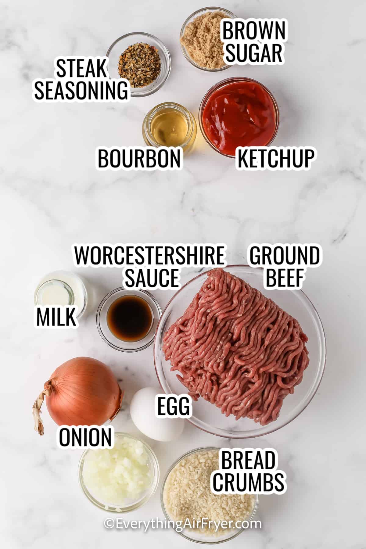 ingredients assembled to make air fryer meatloaf, including ground beef, onion, egg, bread crumbs, ketchup, bourbon, and brown sugar