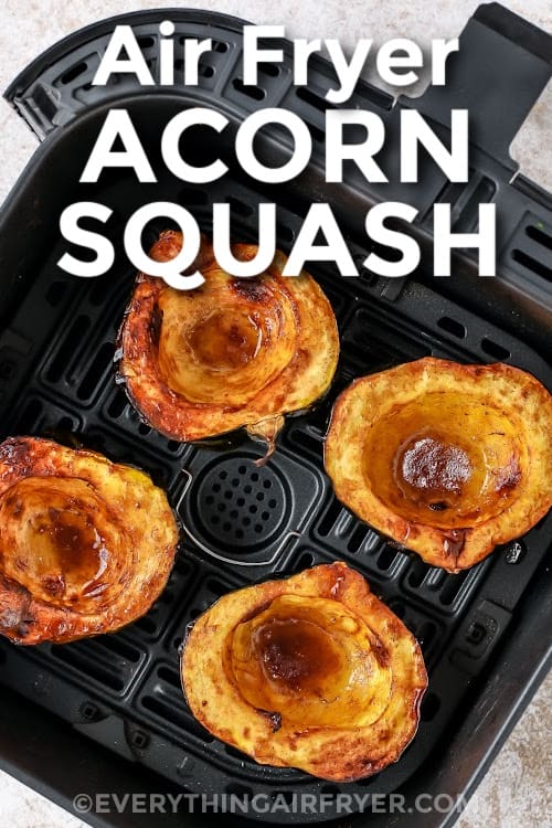 Acorn squash cooked in an air fryer basket with a title