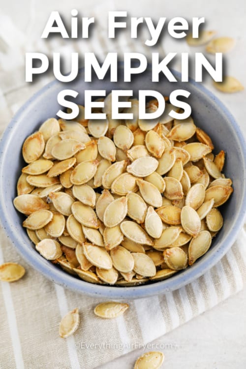 air fryer pumpkin seeds in a bowl with writing