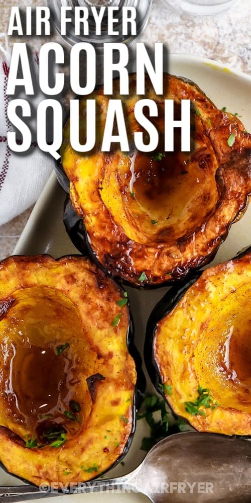 Air fryer acorn squash on a serving plate with a title