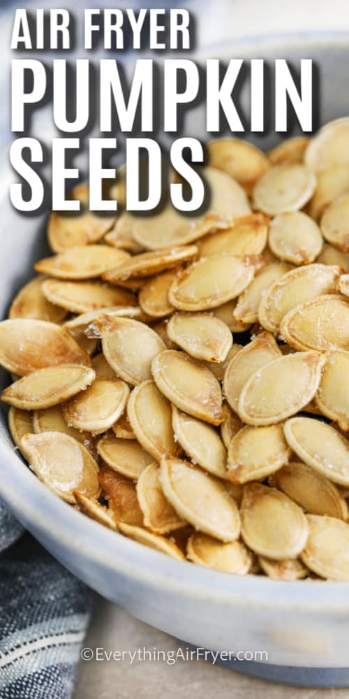 air fryer pumpkin seeds in a bowl with a title