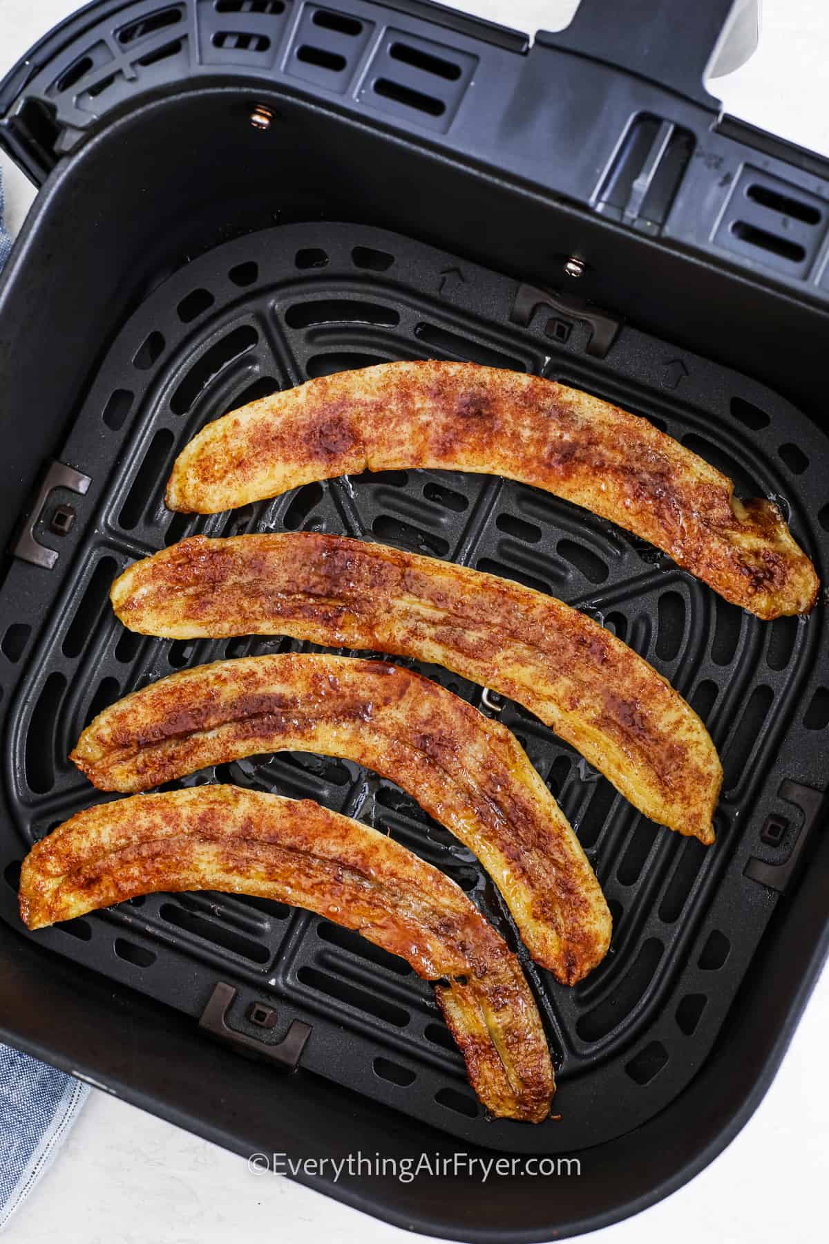 cooked bananas in an air fryer tray